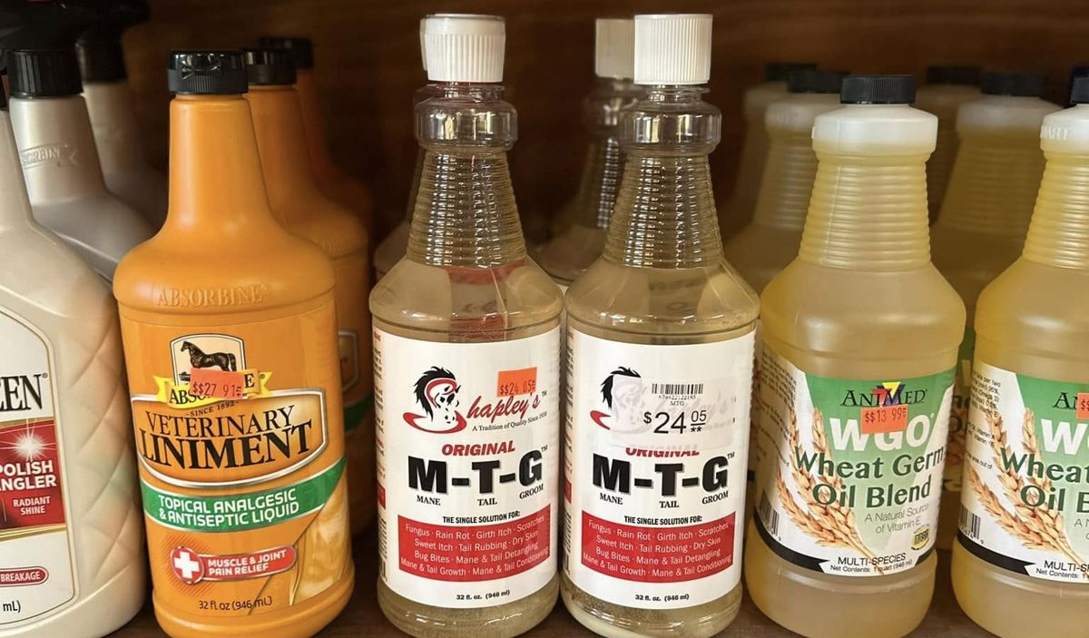 Shelf of Absorbine Veterinary Liniment, Shapley's M-T-G and AniMed Wheat Germ Oil