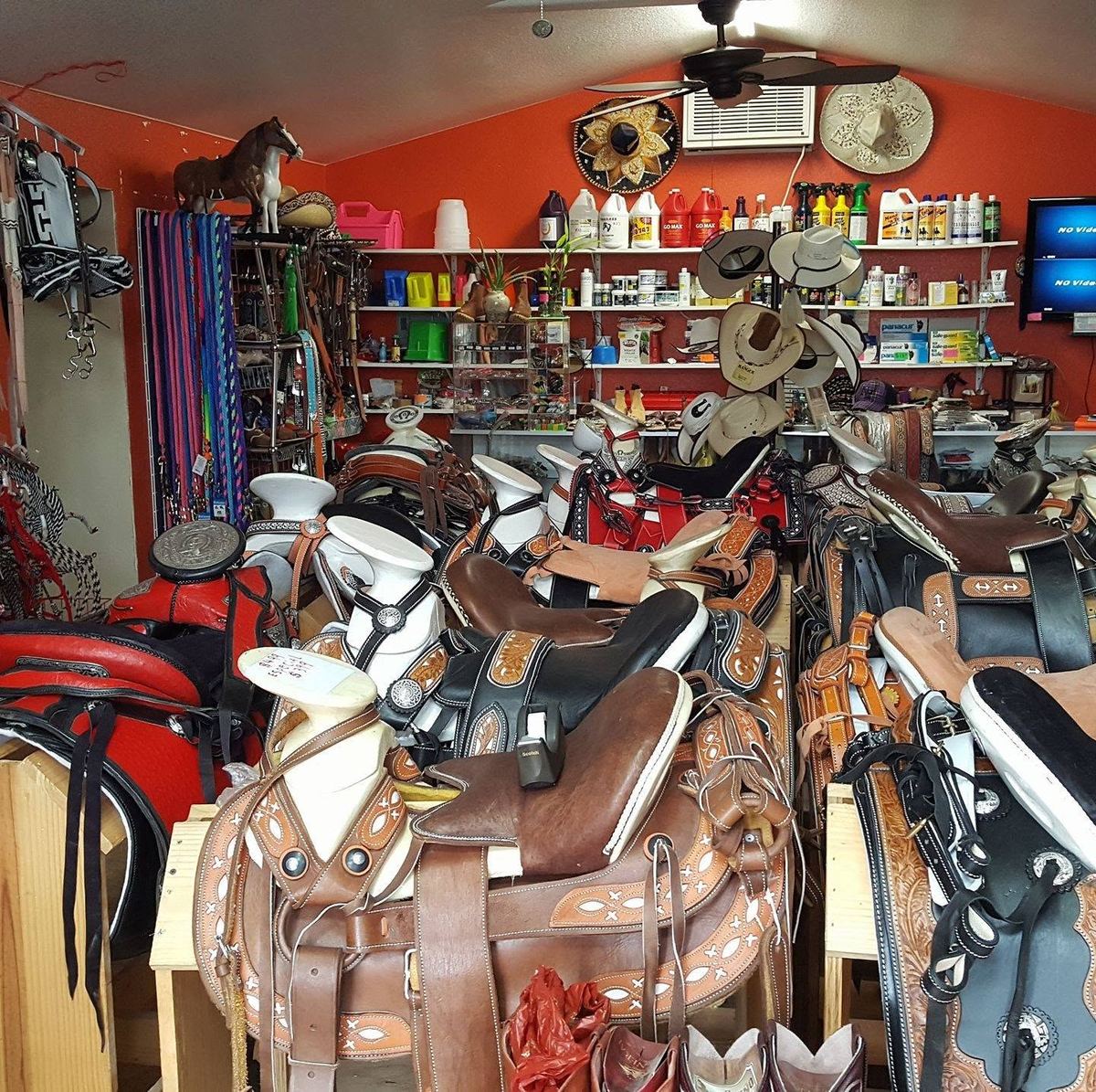 Room full of charro saddles, sombreros and tack